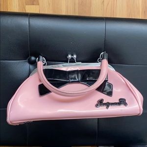 Sourpuss retro pink purse with black bow detail